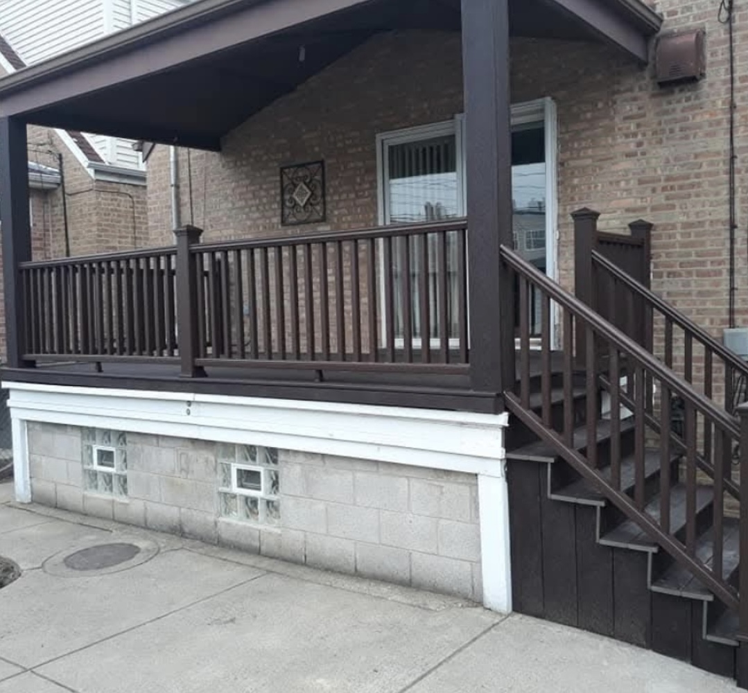 Brick porch with painted railing and staircase